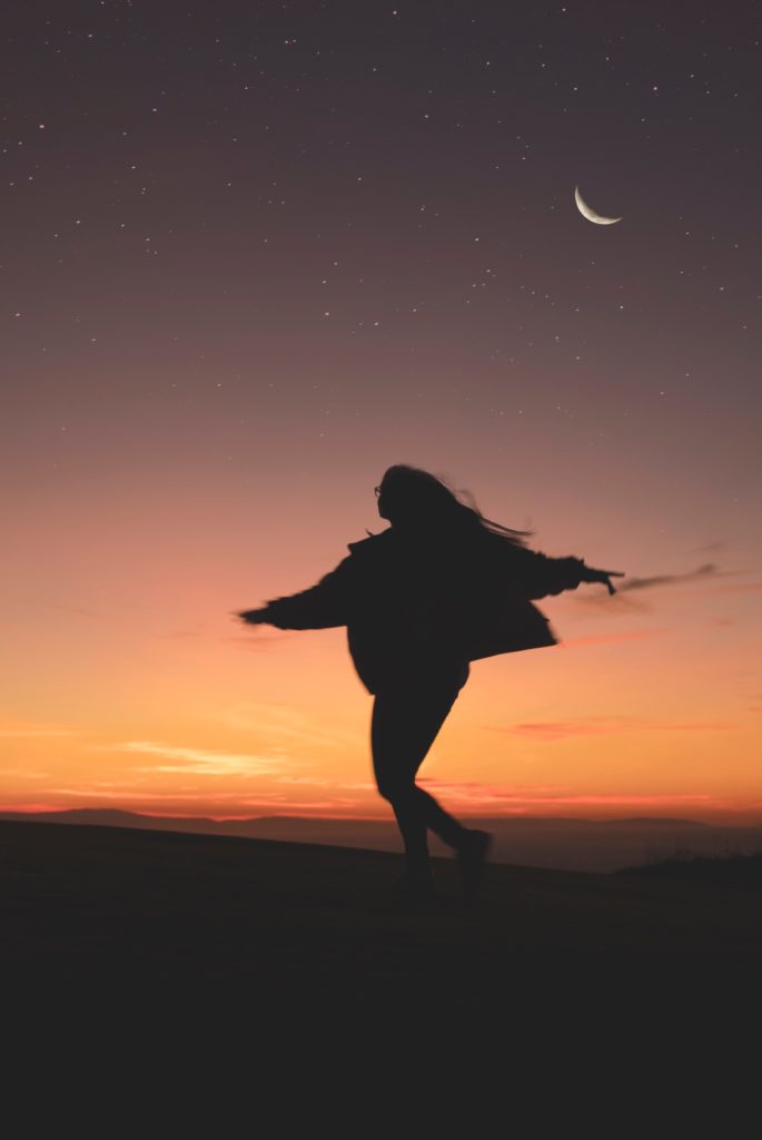 Woman dancing at sunset