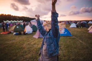 Person dancing at a campsite